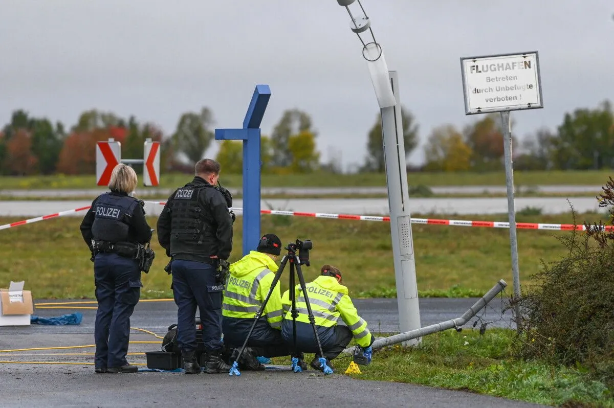 German police say that two men have turned themselves in after a security fence was damaged at Leipzig Airport.