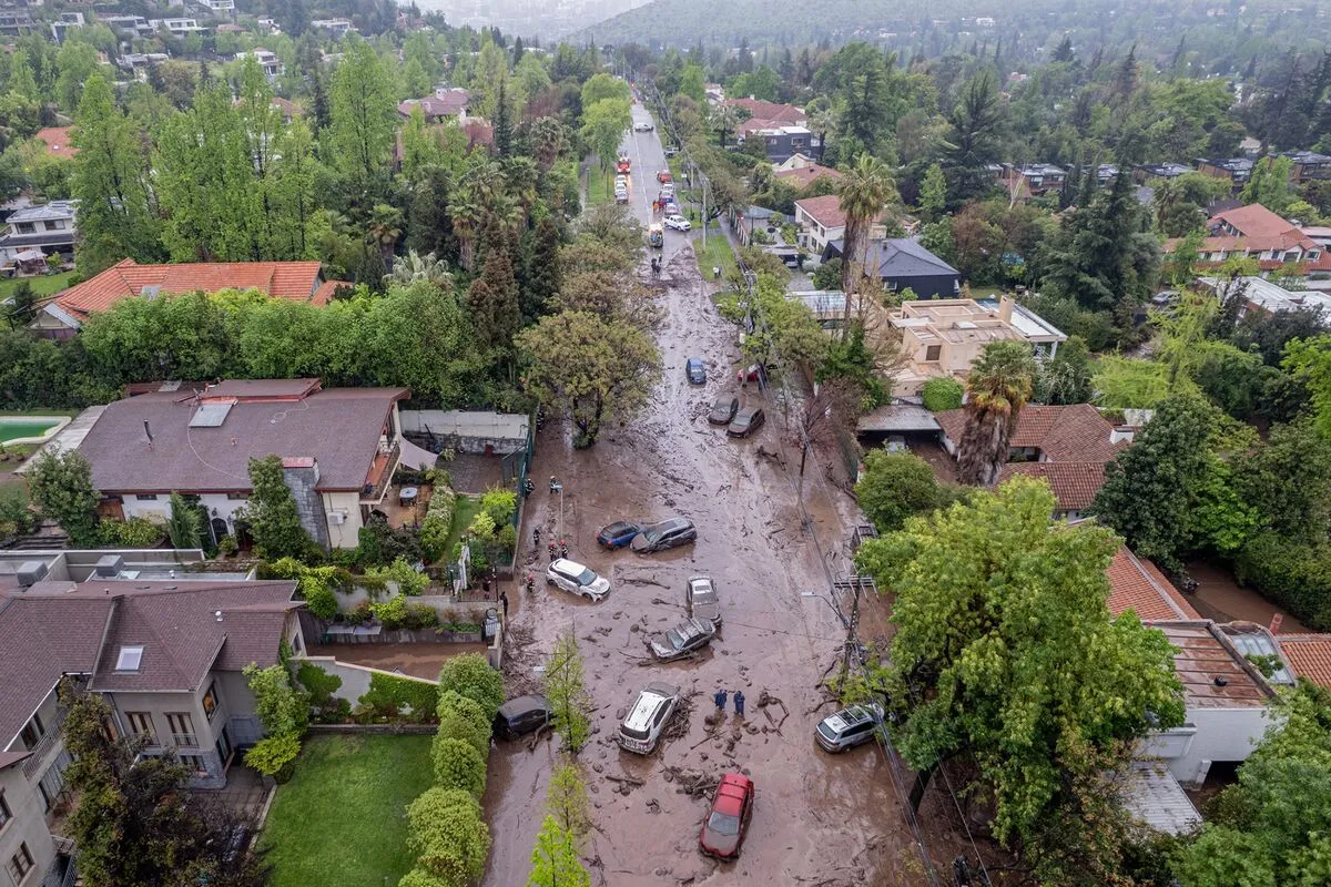 A sudden surge of water and debris swept through the affluent Santiago district of Las Condes on Thursday, dragging…